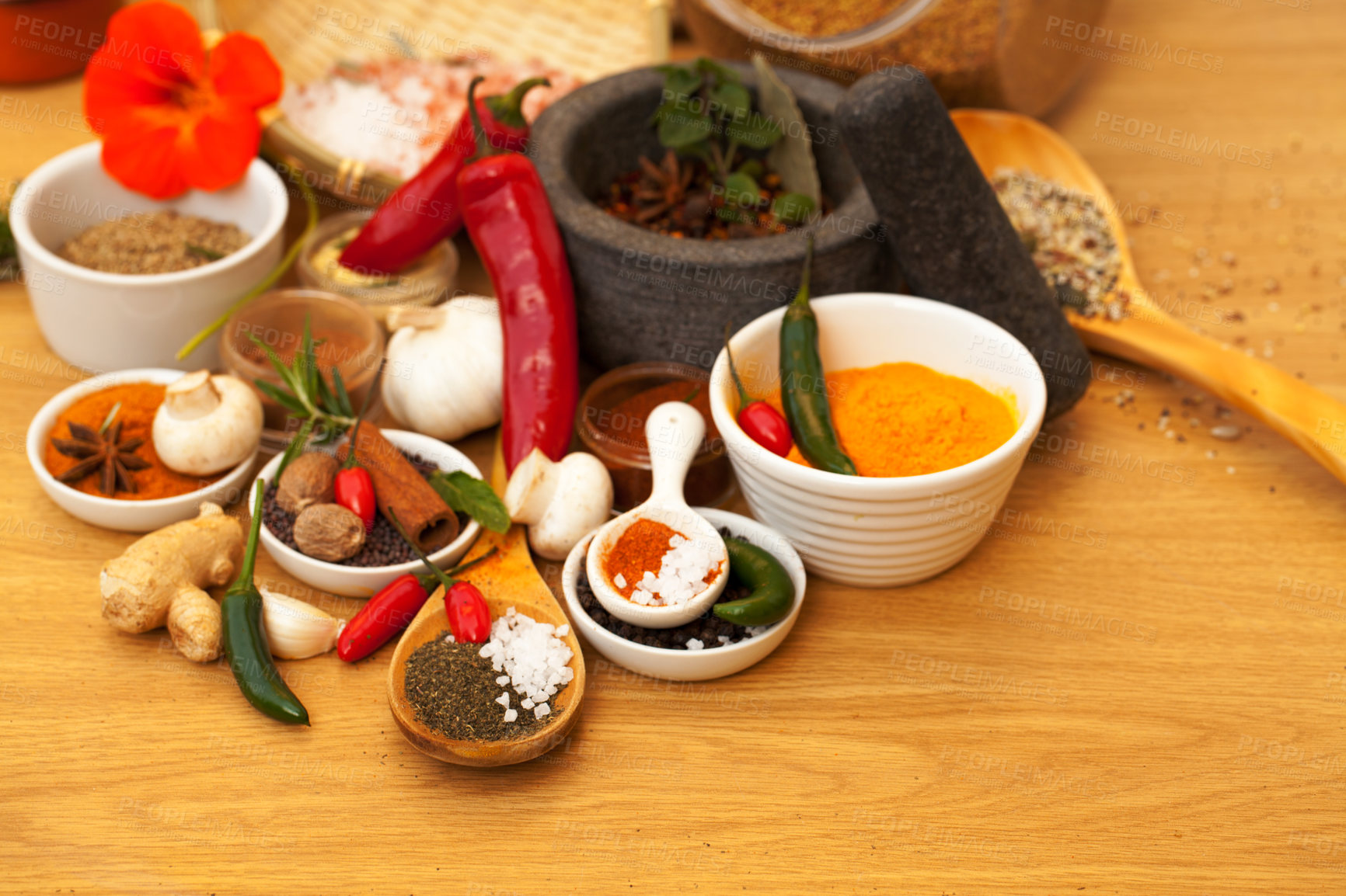 Buy stock photo Mortar, food and spices on table for cooking gourmet meal, chili seasoning or flavor pestle. Pepper vegetables, kitchen condiments and variety of plant herbs for brunch, healthy diet or vitamins.