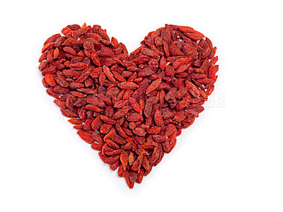 Buy stock photo Studio shot of a pile of goji berries forming a heart shape