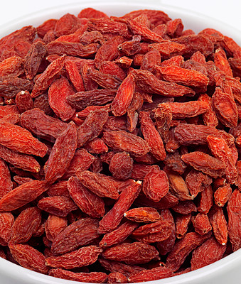 Buy stock photo Dried, goji berries and bowl in studio for nutrition, natural, organic and antioxidant as snack for full body. Fresh, fruit and red seeds produce vitamin c, fibre and nutrients for weight loss 