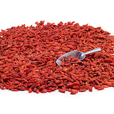 Buy stock photo Studio shot of a pile of goji berries with a metal scoop