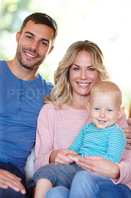 Buy stock photo Portrait of a happy young family sitting at home