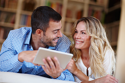 Buy stock photo Happy, woman and tablet with husband at house in lounge for weekend away with love, trust and peace as partners. Married, couple and vacation for break, relax and bonding with technology in home.