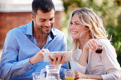 Buy stock photo  Happy couple, smiling and tablet in garden for breakfast, internet and scrolling on social media. Male person, woman and outdoors at home for mobile games, meme and drinking coffee in the morning.