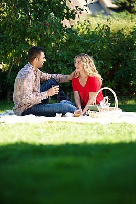 Buy stock photo Happy, couple and picnic in park with basket for food, snacks and drink in outdoor. Man, woman and smiling in enjoying on date with touching, romance and love in summer for bonding or talking