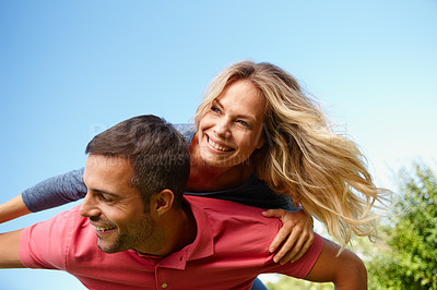 Buy stock photo Couple, smile and blue sky on shoulders and sunny with trees, relationship or holiday with outside. Man, girlfriend and together or happy on vacation or honeymoon, bonding and summer or dating