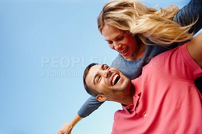 Buy stock photo Couple, piggyback and laugh by blue sky on holiday, love and freedom by flying and play together. People, happy and support on travel and romance in outdoor nature, energy and fun on summer vacation