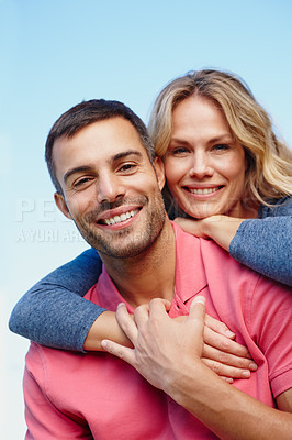 Buy stock photo Couple, portrait and piggyback outdoor with blue sky in nature for love, together and vacation. Man, woman and smile with back ride for happiness, commitment and holiday with romance, date and fun