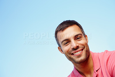 Buy stock photo Man, portrait and smile by blue sky on holiday, peace and freedom on weekend trip. Happy male person, mockup space and tourist face for travel and relax in outdoor nature, getaway and summer vacation
