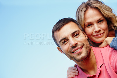 Buy stock photo Couple, portrait and piggyback for marriage by blue sky, outdoor and love in relationship or bonding. People, low angle and hug or embrace on holiday or vacation, relax and commitment on mockup space