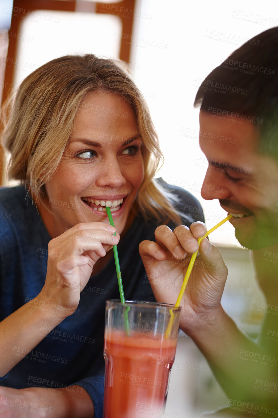 Buy stock photo Happy couple, juice and sharing in house with drink, smile and color straw for relax together. Love, milkshake and happiness of man with woman in home for romantic relationship, date and glass