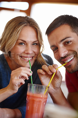 Buy stock photo Portrait, happy couple and sharing in house with drink, smile and color straw for happiness together. Love, milkshake and face of man with woman in home for romantic relationship, date and glass