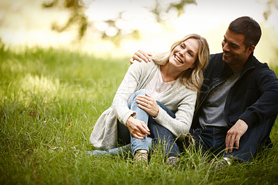 Buy stock photo Couple, embrace and relax outdoors on grass, together and love in relationship or bonding in park. Happy people, support and hug on holiday or vacation in nature, laughing and commitment on date