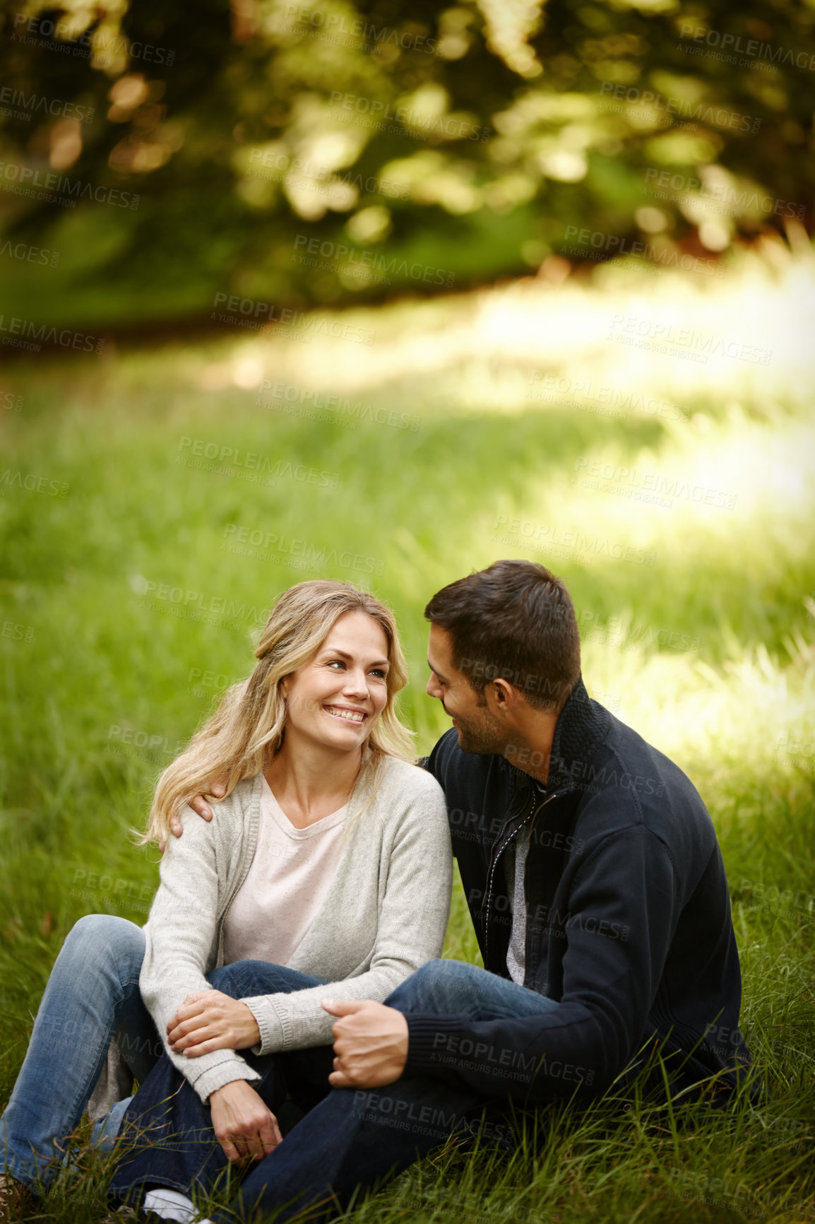 Buy stock photo Couple, embrace and outdoor love on grass, together and care in relationship or bonding in park. Happy people, support and hug on holiday or vacation in nature, relax and commitment on romance date