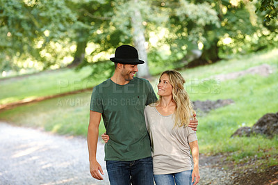 Buy stock photo Couple, hug and happiness walking in park for love, bonding with care and support in healthy relationship. Man, woman and outdoor for date with romance, trust and commitment for marriage or partner