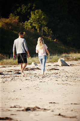 Buy stock photo Couple, walking and bonding on outdoor beach sand, peace and travel to nature for holiday. People, back and calm stroll on weekend or vacation, love and date for relationship or marriage and trip