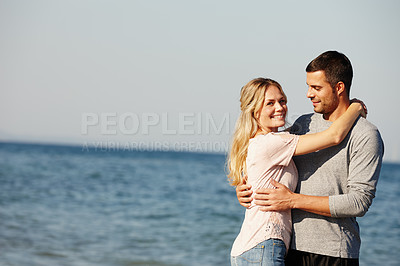 Buy stock photo Couple, portrait and hug by beach for love, peace and travel to nature for holiday. People, embrace and calm on weekend or vacation, blue sky and date for relationship or marriage and ocean waves