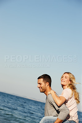 Buy stock photo Couple, carry and piggyback on vacation, ocean and peace at beach or game by blue sky. People, mockup space and tropical island for bonding on weekend, outdoor nature and love for marriage or romance