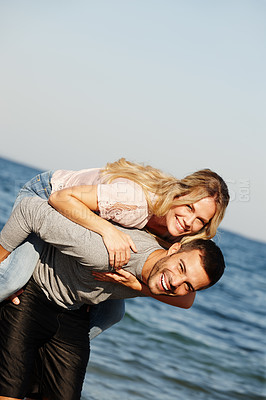 Buy stock photo Couple, portrait and piggyback on vacation, ocean and peace at beach or game by blue sky. People, happy and tropical island for bonding on weekend, outdoor nature and love for marriage or romance