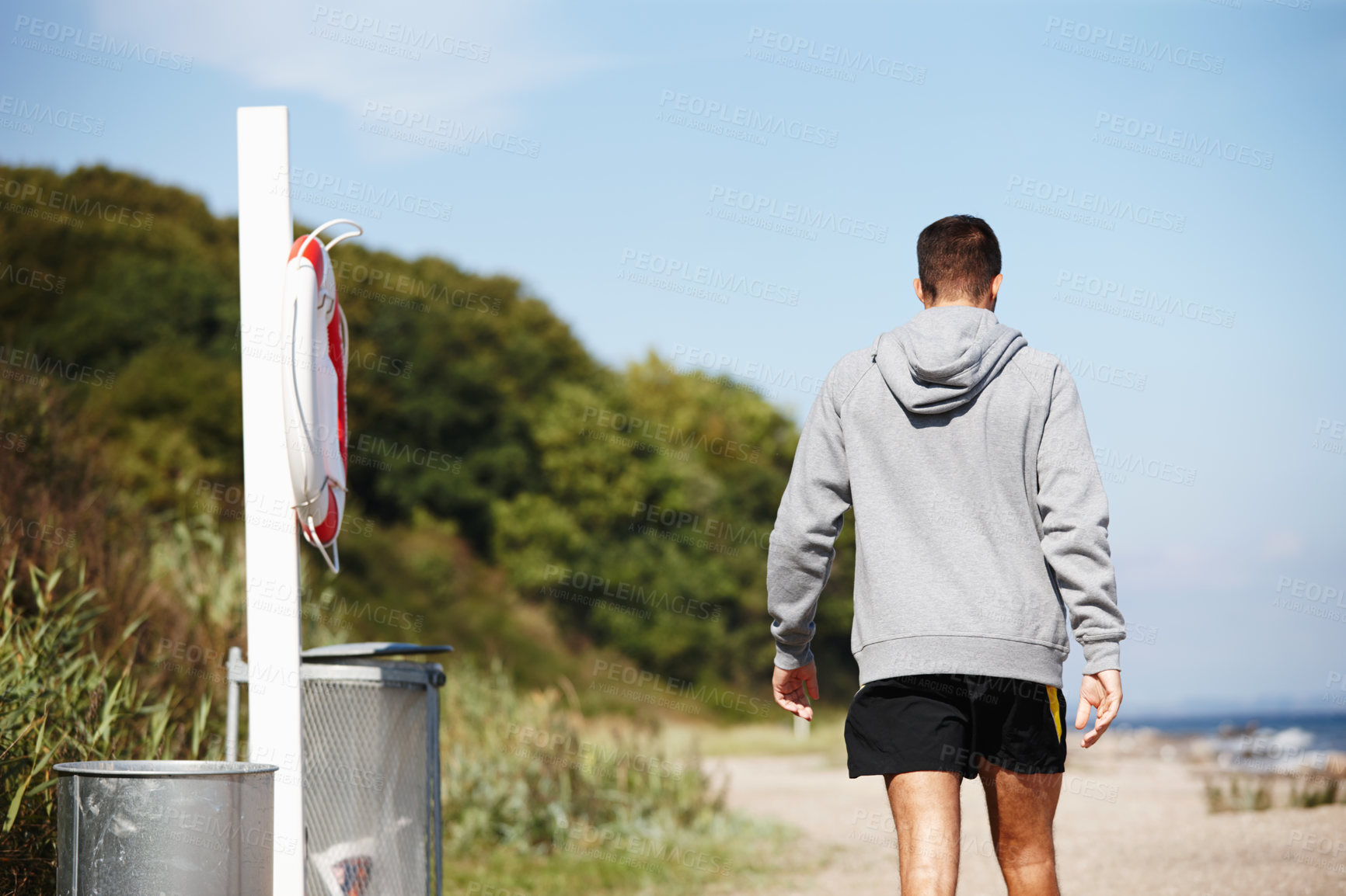 Buy stock photo Rear view, man and jog for exercise on beach for fitness,  workout and body health for physical training. Male runner or athlete and run for cardio, active strength or recreation in summer outside
 