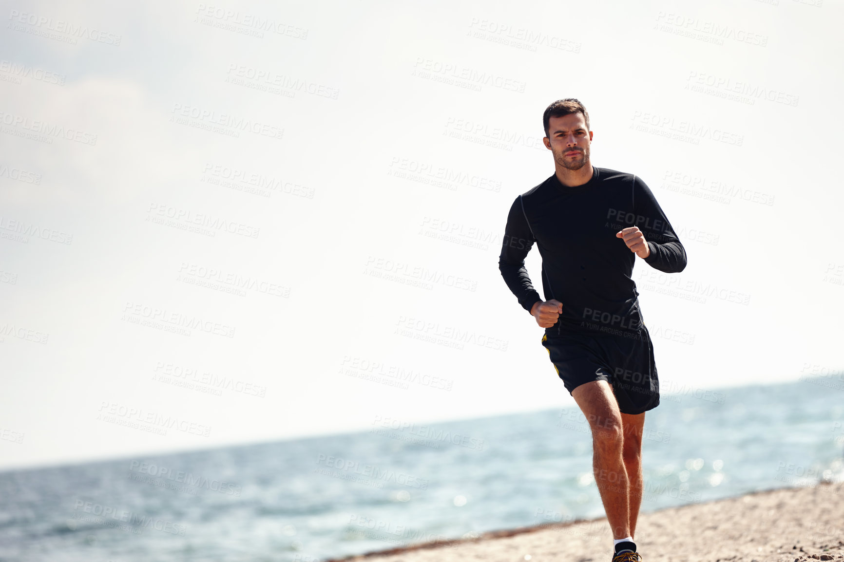 Buy stock photo Running, athlete and man, beach and sports with energy for practice, exercise and health in nature. Workout, runner and training for marathon, sea and performance of speed of male person outdoor