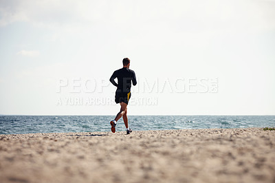 Buy stock photo Sports, man and jogging in outdoor for fitness, health and wellness on beach for workout or exercise. Male athlete, training and cardio with endurance, muscles and strength for healthy living or gym