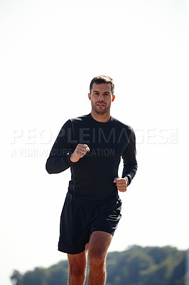 Buy stock photo Running, athlete and man, outdoor and nature with energy for practice, exercise and health with sports. Workout, runner and training for marathon, forest and performance of speed of male person