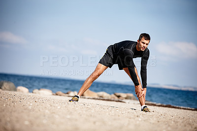 Buy stock photo Man, stretching and sports at beach for exercise with fitness motivation, sand and blue sky. Male person, training and nature by ocean with workout for wellness, strong body and health activity