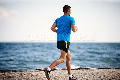 Buy stock photo Running, athlete and man, sports and outdoor with energy for practice, exercise and health in nature. Workout, runner and training for marathon, beach and performance of speed for person outdoor