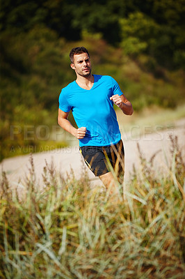 Buy stock photo Running, athlete and man, grass and outdoor with energy for practice, exercise and health in nature. Workout, runner and training for marathon, forest and performance of speed for male person