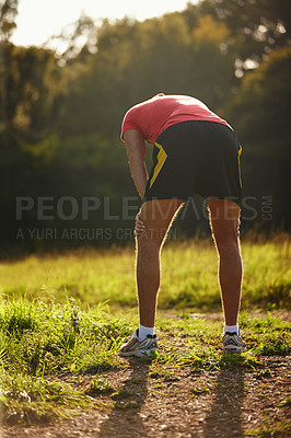 Buy stock photo Man, tired and sunshine in outdoor for exercise with breathing, running and physical workout. Male person, fatigue and cardio training with grass for wellness, strong body and fitness motivation