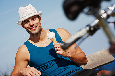 Buy stock photo Man, ice cream and portrait with bike for relax outdoor, travel and break for recreation on summer holiday. Young person, smile and sitting with dessert cone for weekend fun and gelato sorbet outside