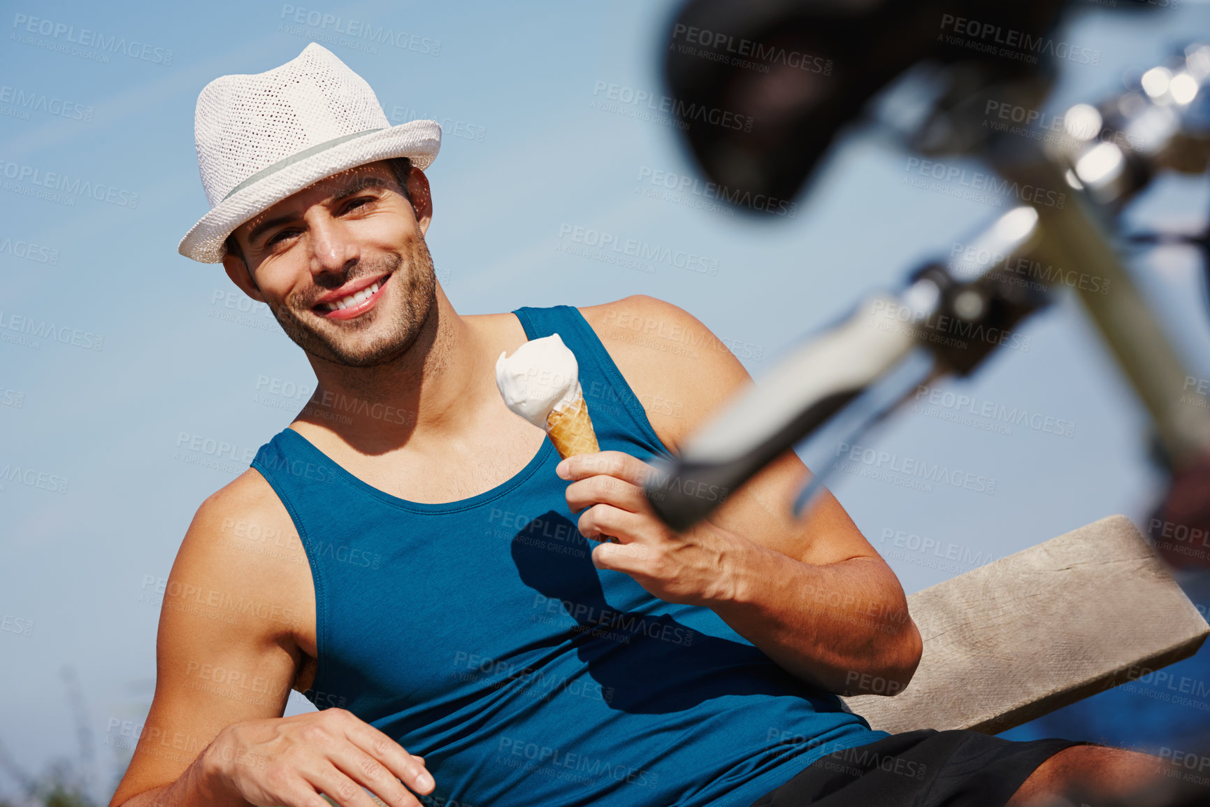 Buy stock photo Man, ice cream and portrait with bike for relax outdoor, travel and break for recreation on summer holiday. Young person, smile and sitting with dessert cone for weekend fun and gelato sorbet outside