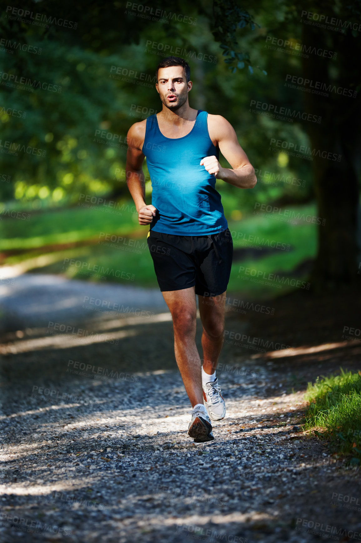 Buy stock photo Man, fit and running in outdoor for exercise, health and wellness in nature for workout or fitness. Male athlete, training and cardio with endurance, muscles and strength for healthy living or gym