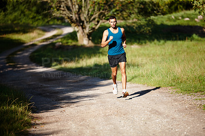 Buy stock photo Running, athlete and man, outdoor and practice with energy for sports, exercise and health in nature. Workout, runner and training for marathon, forest and performance of speed of male person