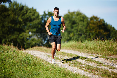 Buy stock photo Sporty, man and jogging in nature for fitness, health and wellness in outdoor for workout or exercise. Male athlete, training and cardio with endurance, muscles and strength for healthy living or gym