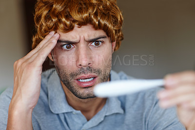 Buy stock photo Shocked, sick and man with fever on thermometer at home from cancer recovery is wearing wig. Frustrated, person and antibiotic medicine for illness, disease and medical treatment of influenza virus