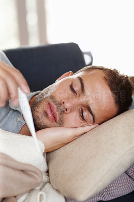 Buy stock photo Man in living room, sick and thermometer for fever, healthcare and wellness with virus, viral infection or bacteria. Burnout, fatigue and health fail, monitor condition for illness with flu at home