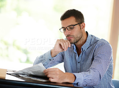 Buy stock photo Newspaper, reading and thinking with business man at desk in office for information or media. Company, idea and planning with young employee in glasses to research news update for professional work