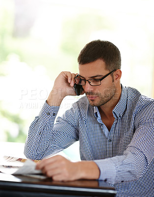 Buy stock photo Man, home and phone call while reading an article, networking and newspaper for information. Serious male person, smile and app for conversation on morning, internet and story or weekend connection