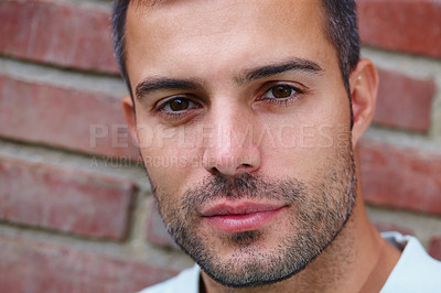 Buy stock photo Portrait, serious and man with confidence by brick wall or background with beard, face or pride. Outdoor, model and person with natural skincare, wellness or masculine beauty in urban city or town 