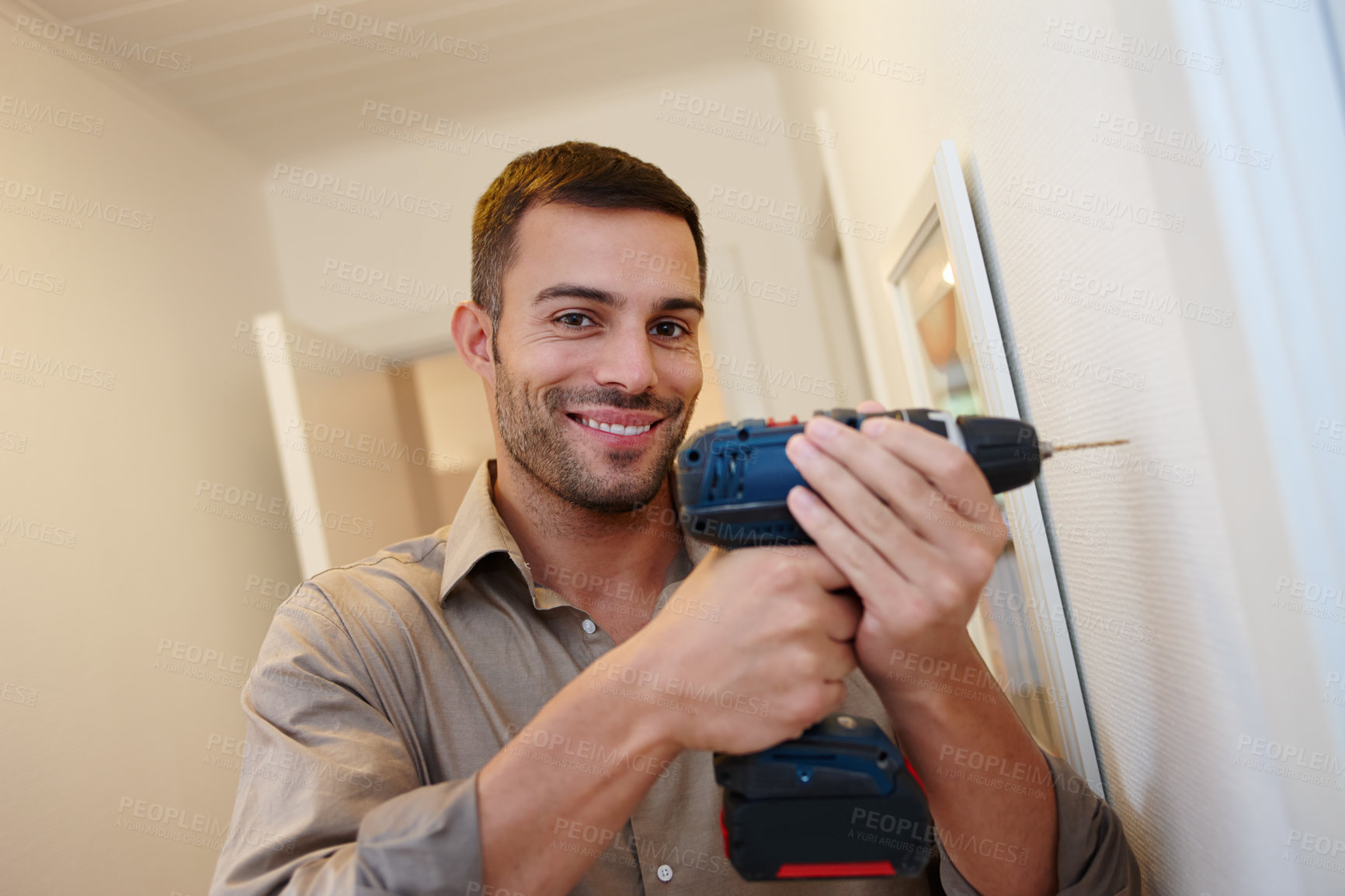 Buy stock photo Portrait, smile and drill for maintenance, handyman and home improvement for wall or house. Manual labour, tools and DIY with equipment, renovation and household construction for contractor repair