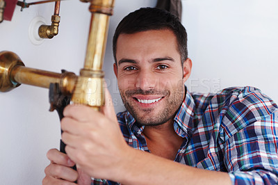 Buy stock photo Portrait, man and plumber for fixing pipe as maintenance contractor for repair of leak from kitchen sink. Happy, person and technician with equipment, tools and wrench for home improvement 