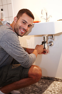 Buy stock photo Portrait, sink and handyman for maintenance, plumber and home improvement for bathroom or house. Manual labour, tools and service with wrench, renovation and household construction for pipe repair