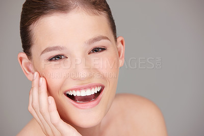 Buy stock photo Happy topless woman showing teeth after whitening treatment. Closeup portrait of beautiful woman touching cheek with hand. Smiling model posing isolated on grey background in studio with copyspace. 