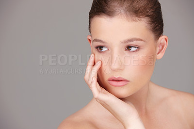 Buy stock photo Skincare, beauty and woman thinking in studio for cosmetology, wellness or facial treatment with gray background. Dermatology, serious and female model for healthy skin, luxury salon or natural glow