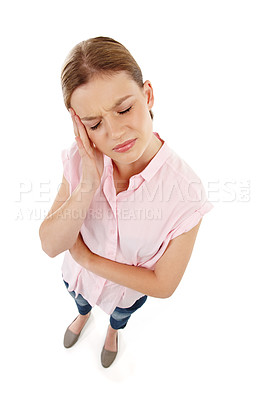 Buy stock photo Young woman suffering from a headache and feeling stressed because of chronic pain while isolated on a white background. Depressed female standing with her eyes closed and her hand against her face