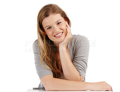 Buy stock photo A portrait of a young relaxed girl with her head in her hand, isolated on a studio background. A stylish blonde teenager smiling confidently with her perfect white teeth after a dentist consultation