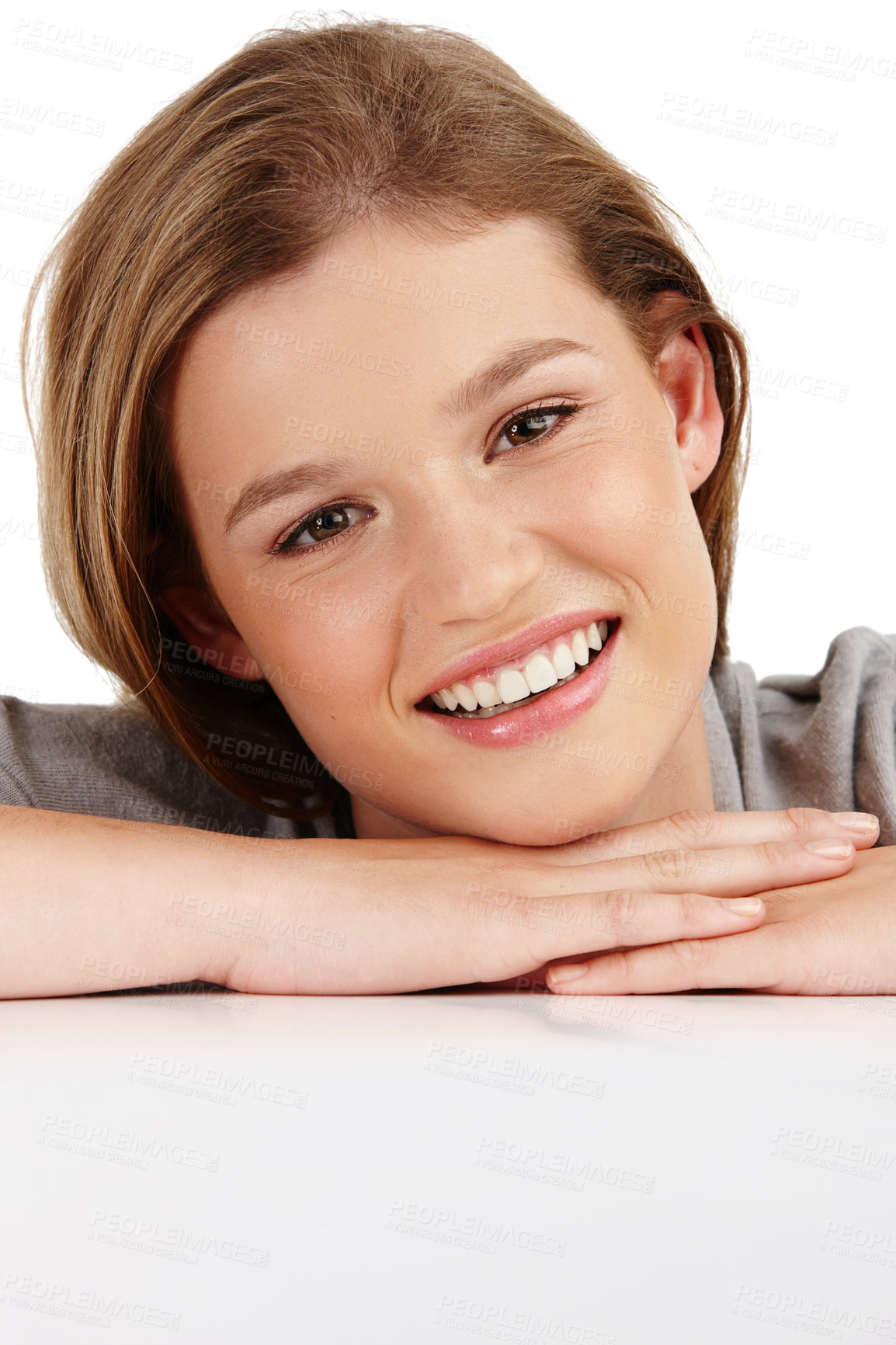 Buy stock photo Studio, table or skincare portrait of girl with dermatology or confident smile isolated on white background. Model, relax and teenager with glow on face, natural beauty and rest on hands in mockup