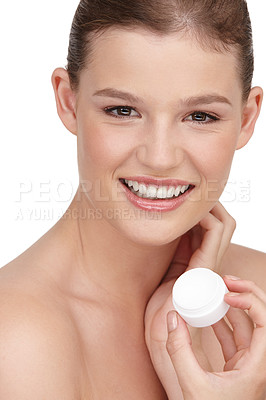 Buy stock photo Close-up shot of a pretty teenage girl holding a tub of moisturizer