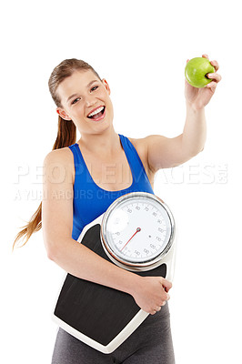 Buy stock photo A pretty teenager holding an apple in her hand while carrying a scale